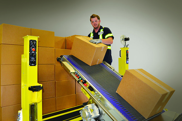 Worker with boxes on conveyor belt